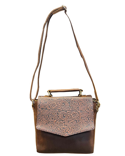Brown leather handbag with floral embossing on a white background