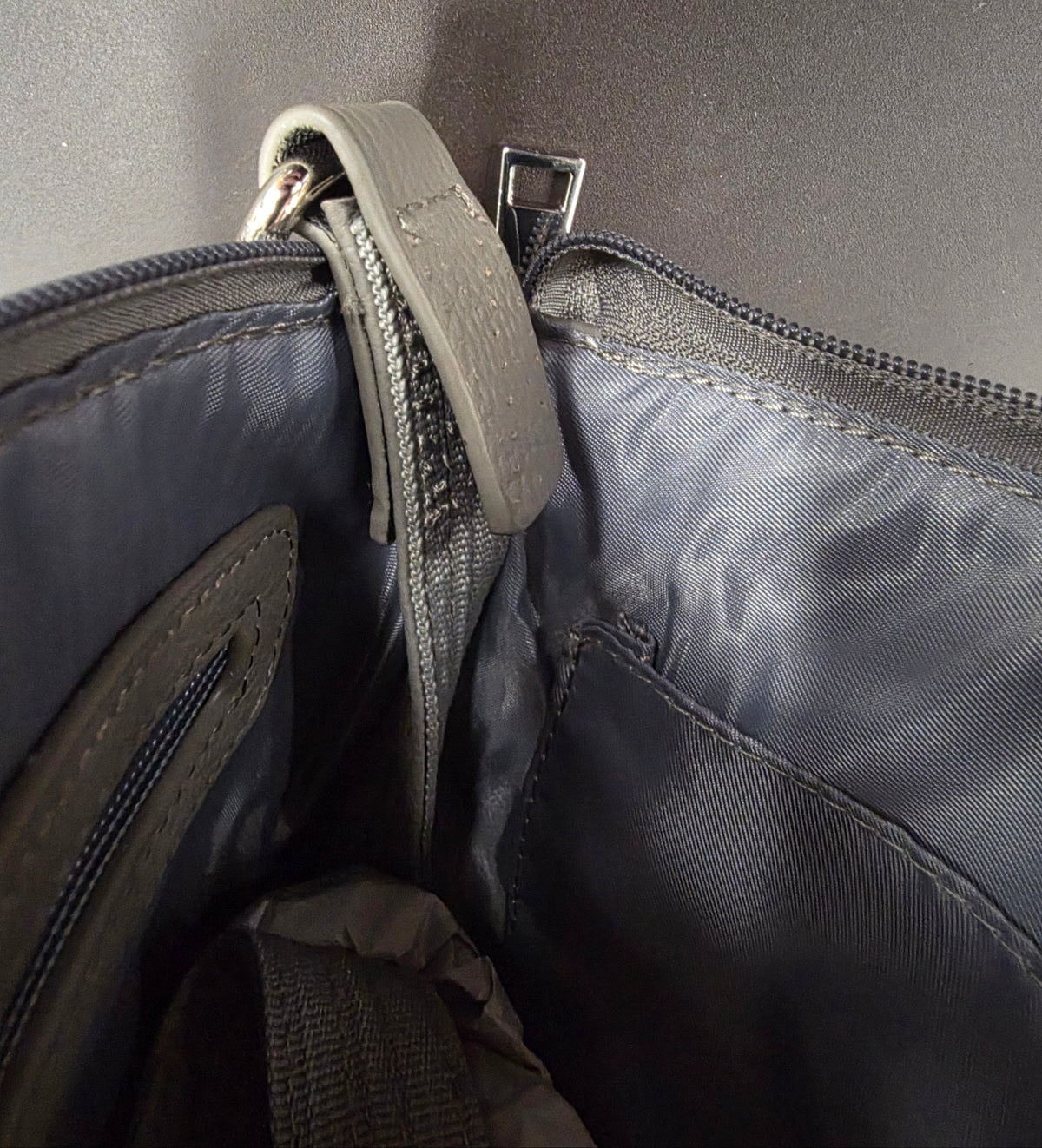 inside of purse showing stitching has come undone
