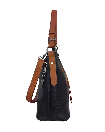A black pebbled leather bucket bag with tan leather trim and straps, shown from a side profile view against a plain white background.