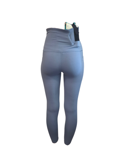 Blue leggings with a black waistband on a white background