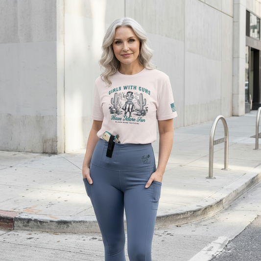 Woman wearing a Black Rose Tactical shirt and blue leggings standing on a sidewalk.