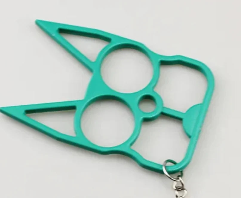 A bright teal green self-defense keychain featuring a multi-finger knuckle protector design with a small silver metal clasp at the bottom, shown on a plain light background.