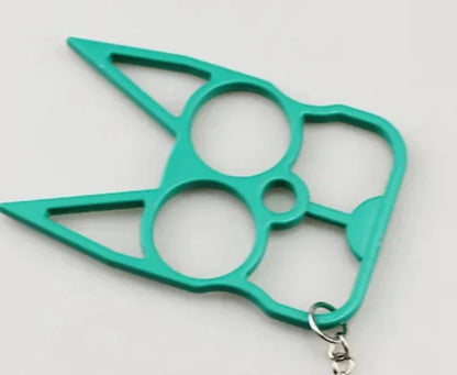 A bright teal green self-defense keychain featuring a multi-finger knuckle protector design with a small silver metal clasp at the bottom, shown on a plain light background.