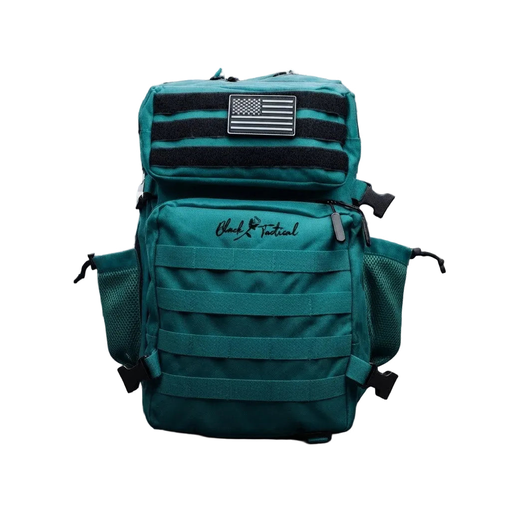A teal tactical backpack with black webbing, a black-and-white American flag patch, and a black script logo on the front, shown against a gray and white checkerboard background.