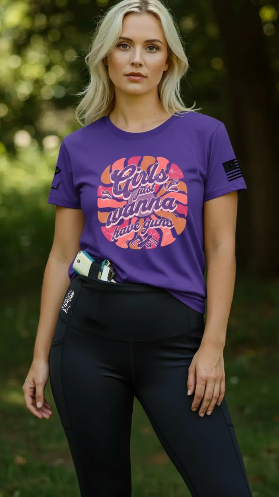 Woman wearing a purple t-shirt with a graphic design and concealed carry leggings outdoors