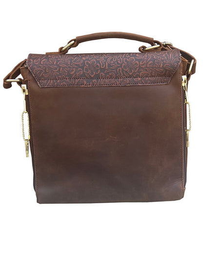 Brown leather handbag with floral patterned flap and gun compartment on a white background