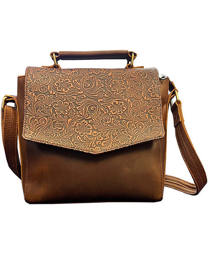 Brown leather handbag with embossed design on a white background