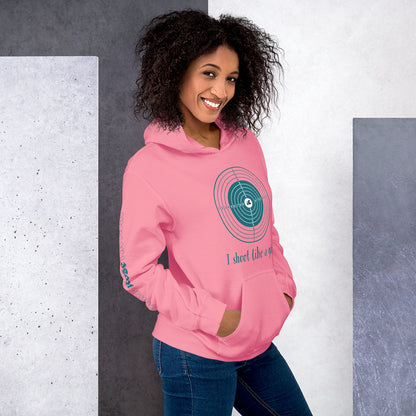 Woman wearing a pink hoodie with a graphic design and text, standing against a gray and white background.