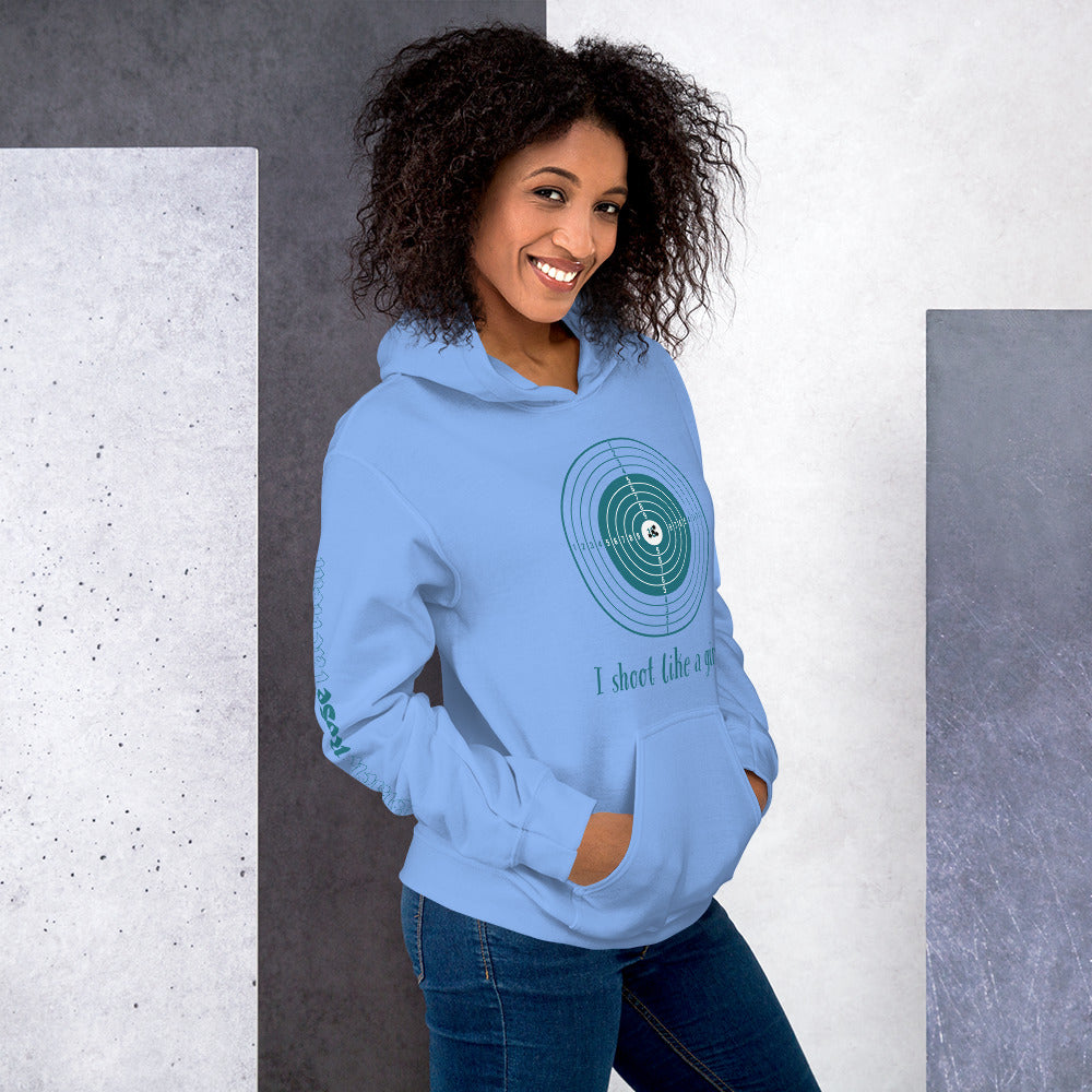 Woman wearing a light blue hoodie with a green graphic design against a gray and white background