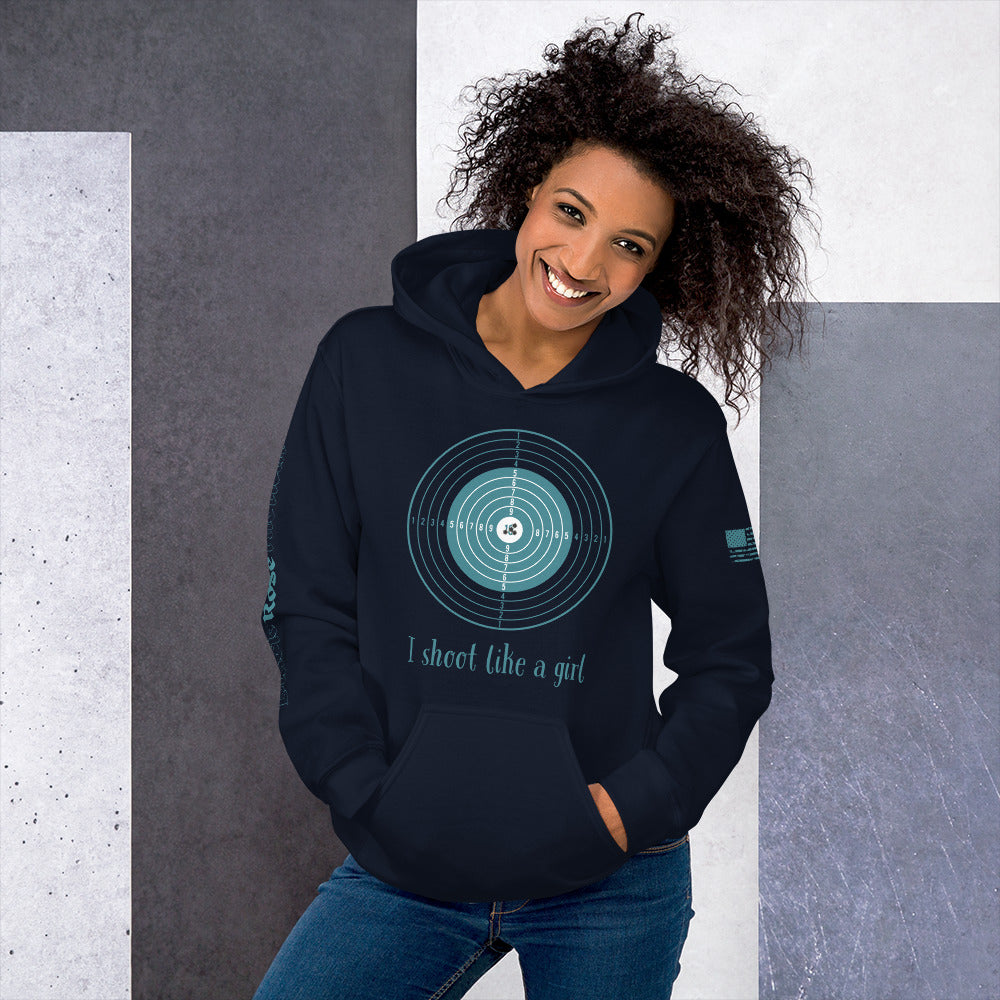 Woman wearing a navy hoodie with a graphic design and text, standing against a gray and white background.