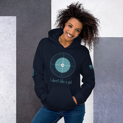 Woman wearing a navy hoodie with a graphic design and text, standing against a gray and white background.