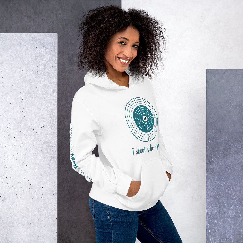 Woman wearing a white hoodie with a graphic design and text, standing against a gray and white wall.