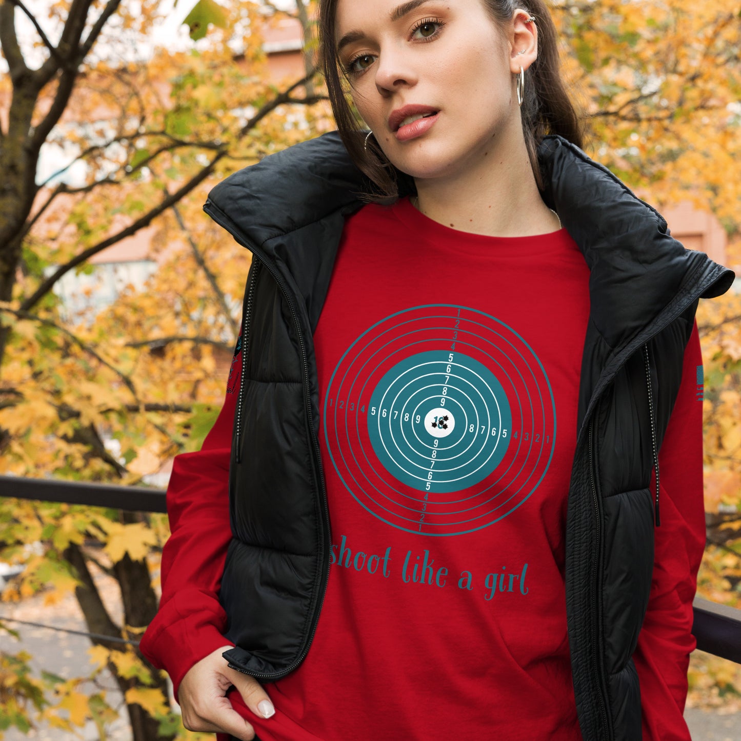 Model wearing I Shoot Like a Girl long sleeve shirt standing outdoors