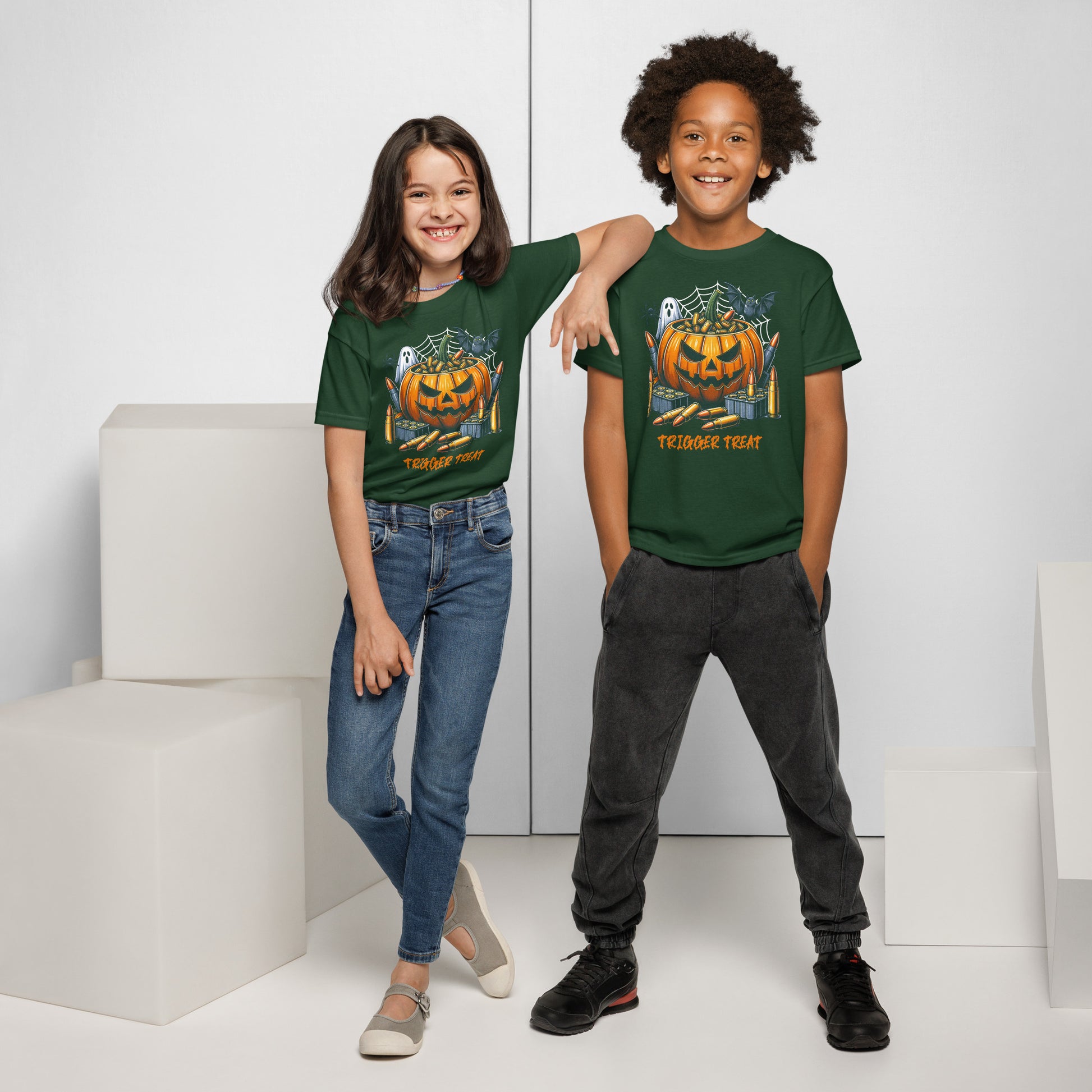 Two children wearing green t-shirts with a pumpkin design on a white background